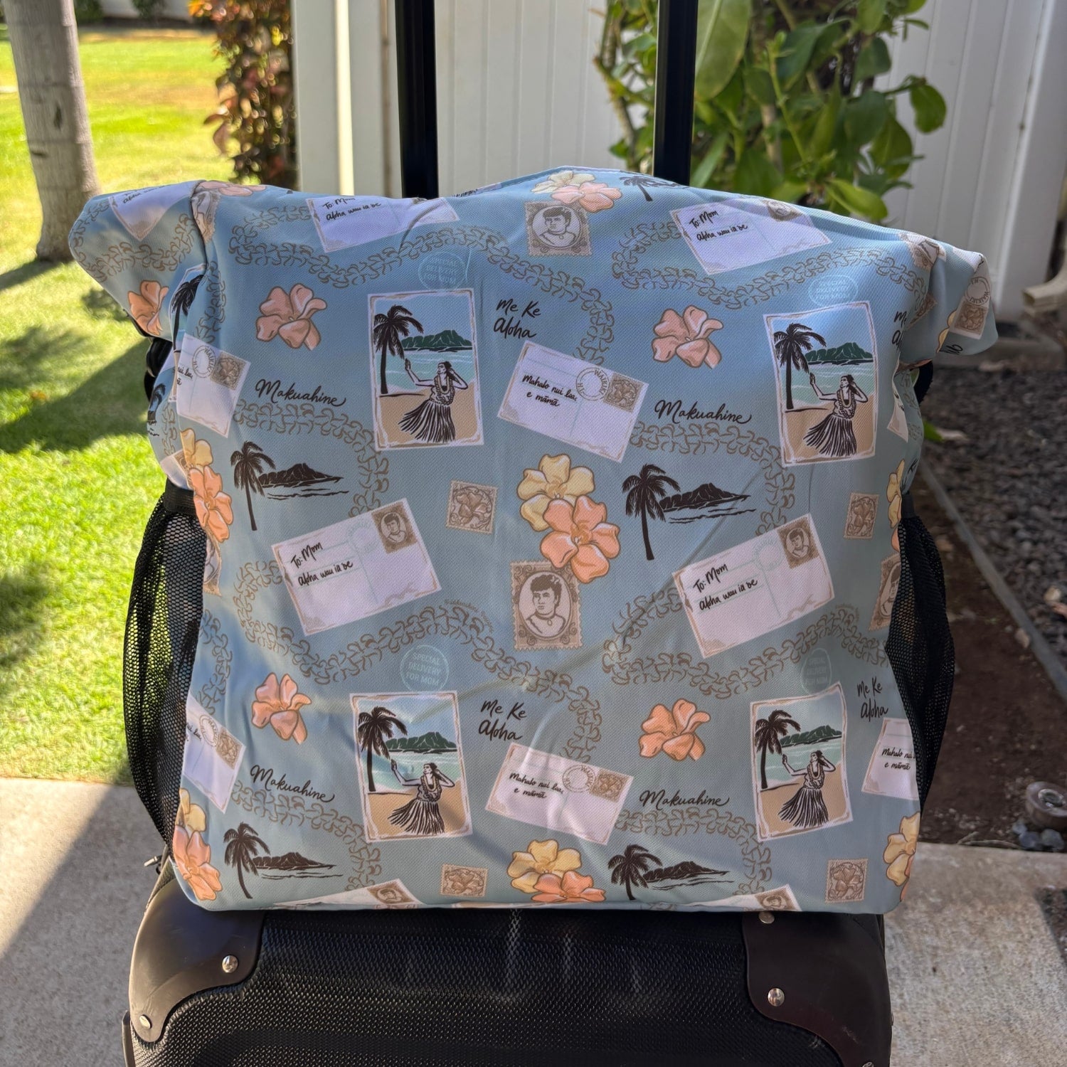 Pua kenikeni Holoholo Bag for travel with crossbody strap from Puakenikeni Designs - use for beach, diaper bag, handbag, hula bag from Puakenikeni Designs on a suitcase