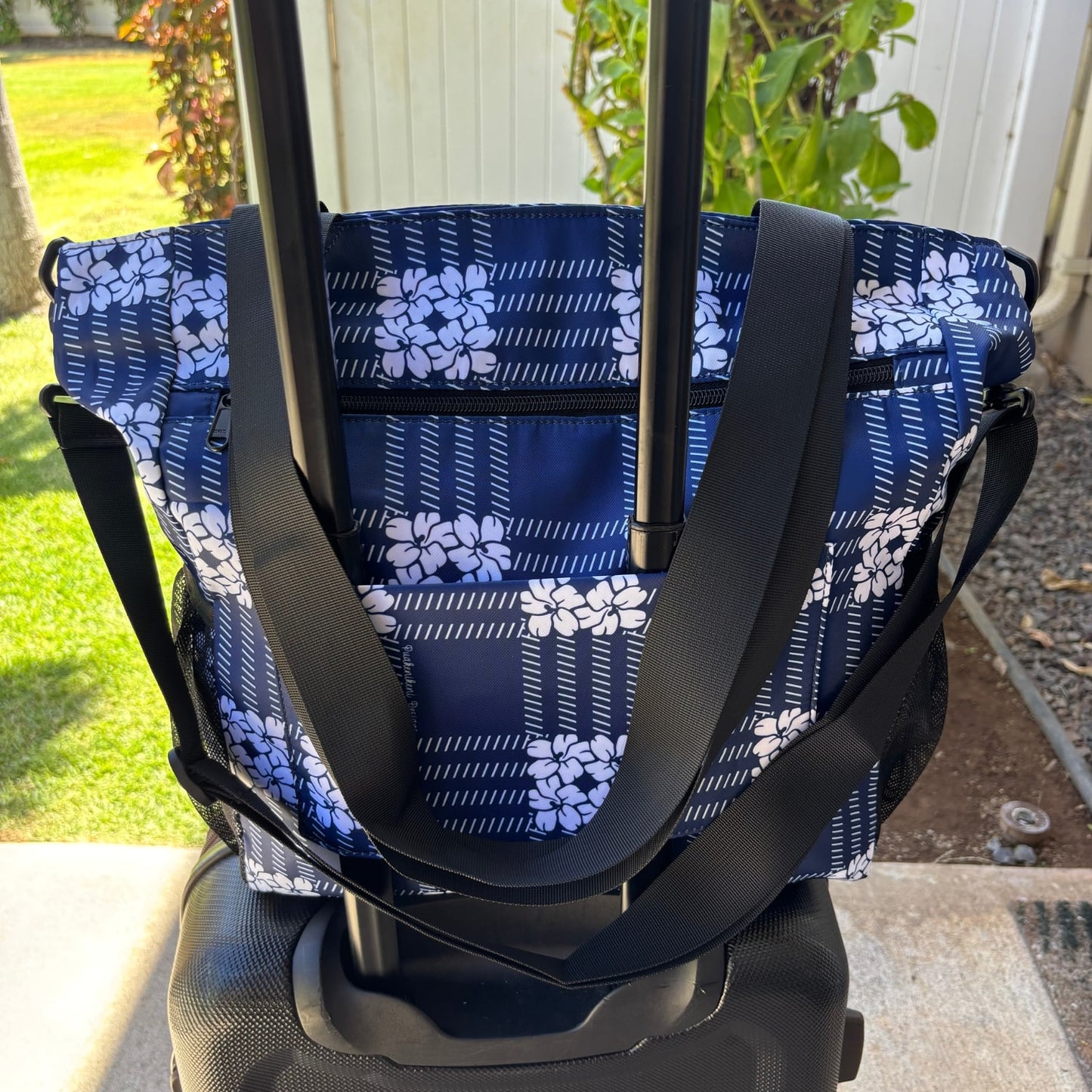 Pua kenikeni Holoholo Bag for travel with crossbody strap from Puakenikeni Designs - use for beach, diaper bag, handbag, hula bag from Puakenikeni Designs on a suitcase showing back strap