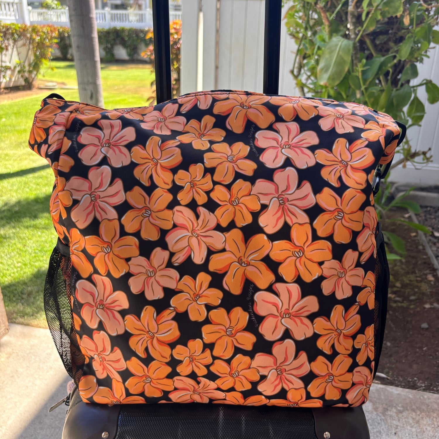 Pua kenikeni Holoholo Bag for travel with crossbody strap from Puakenikeni Designs - use for beach, diaper bag, handbag, hula bag from Puakenikeni Designs on a suitcase