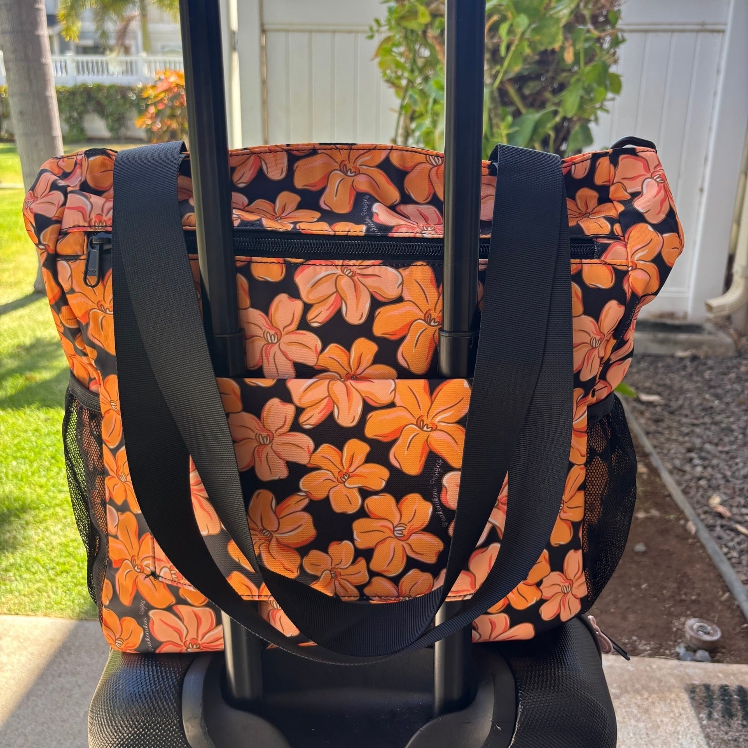 Pua kenikeni Holoholo Bag for travel with crossbody strap from Puakenikeni Designs - use for beach, diaper bag, handbag, hula bag from Puakenikeni Designs on a suitcase showing back strap